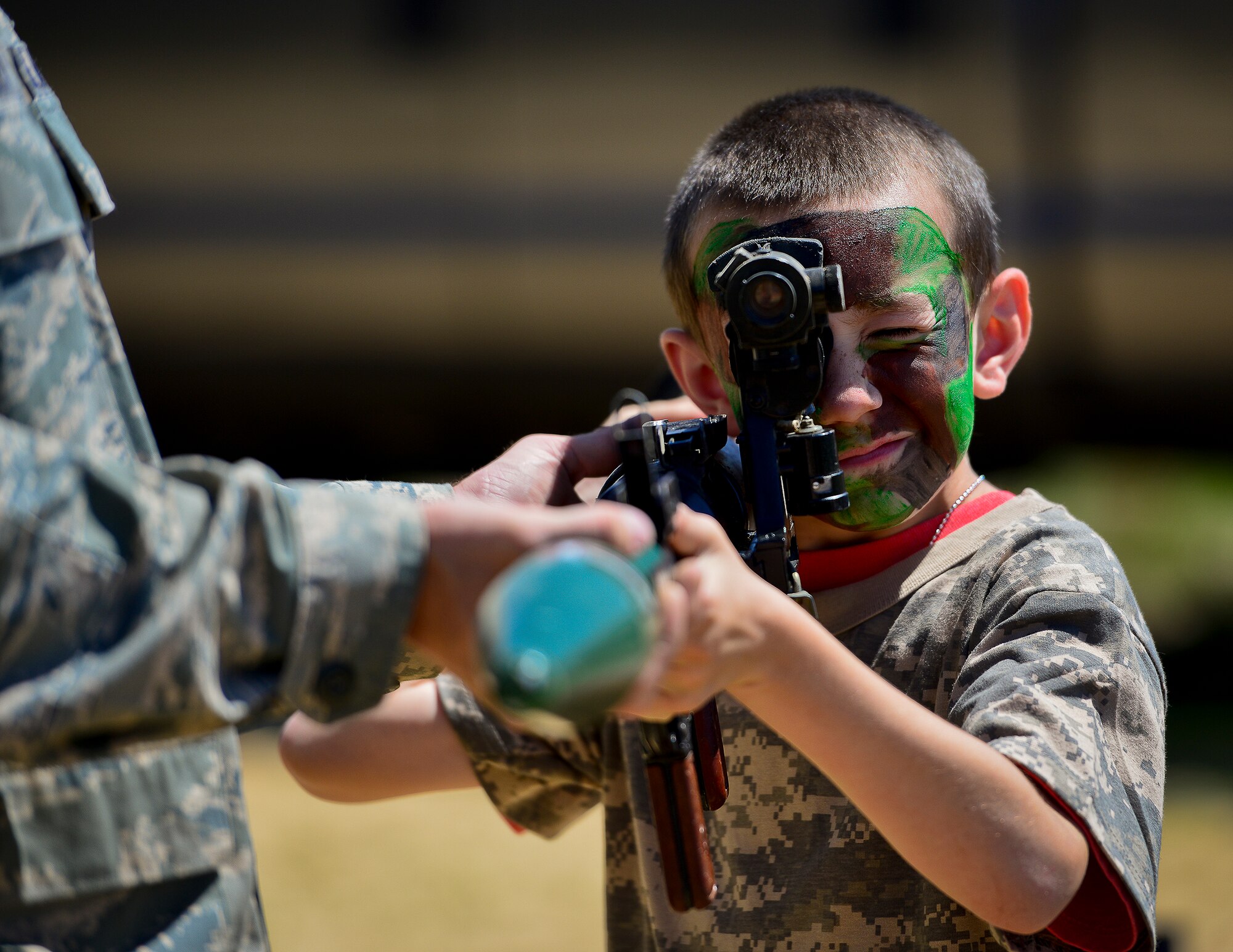 A little deployer tries out a rocket launcher during Operation Hero April 12 at Eglin Air Force Base, Fla.  Nearly 400 adults and children participated in the program this year, which served as a way to help children understand the military and the deployment process their parents have or could face.  The kids went through a deployment line to get their uniforms, dog tags and shots before they were briefed by their commander and shipped off to a deployed location.  There, they encountered military demonstrations, equipment and obstacle courses.  (U.S. Air Force photo/Samuel King Jr.)