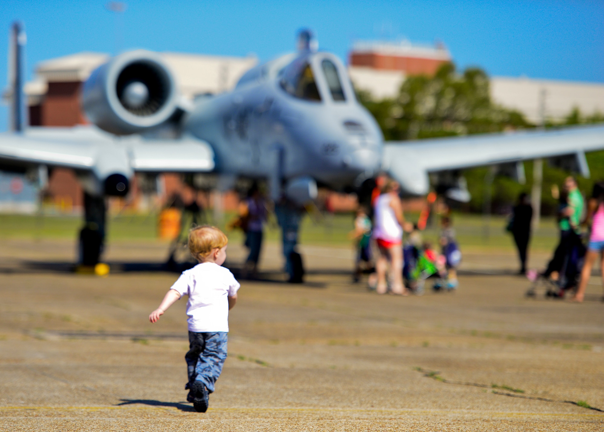 A little deployer runs to check out the A-10 Thunderbolt II during Operation Hero April 12 at Eglin Air Force Base, Fla.  Nearly 400 adults and children participated in the program this year, which served as a way to help children understand the military and the deployment process their parents have or could face.  The kids went through a deployment line to get their uniforms, dog tags and shots before they were briefed by their commander and shipped off to a deployed location.  There, they encountered military demonstrations, equipment and obstacle courses.  (U.S. Air Force photo/Samuel King Jr.)