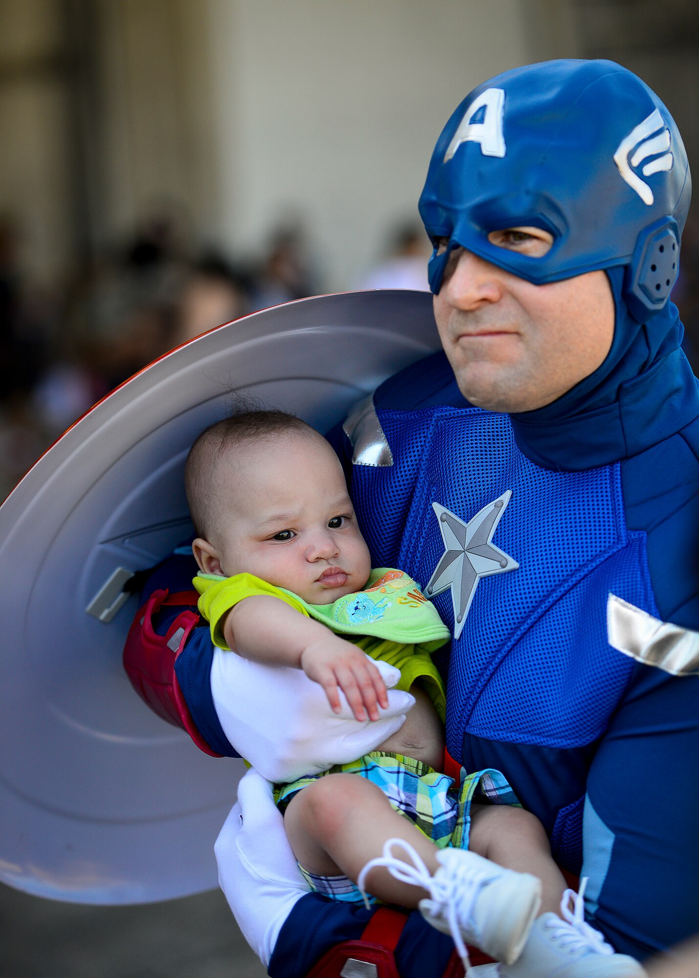 Captain America shields a little deployer during Operation Hero April 12 at Eglin Air Force Base, Fla.  Nearly 400 adults and children participated in the program this year, which served as a way to help children understand the military and the deployment process their parents have or could face.  The kids went through a deployment line to get their uniforms, dog tags and shots before they were briefed by their commander and shipped off to a deployed location.  There, they encountered military demonstrations, equipment and obstacle courses.  (U.S. Air Force photo/Samuel King Jr.)