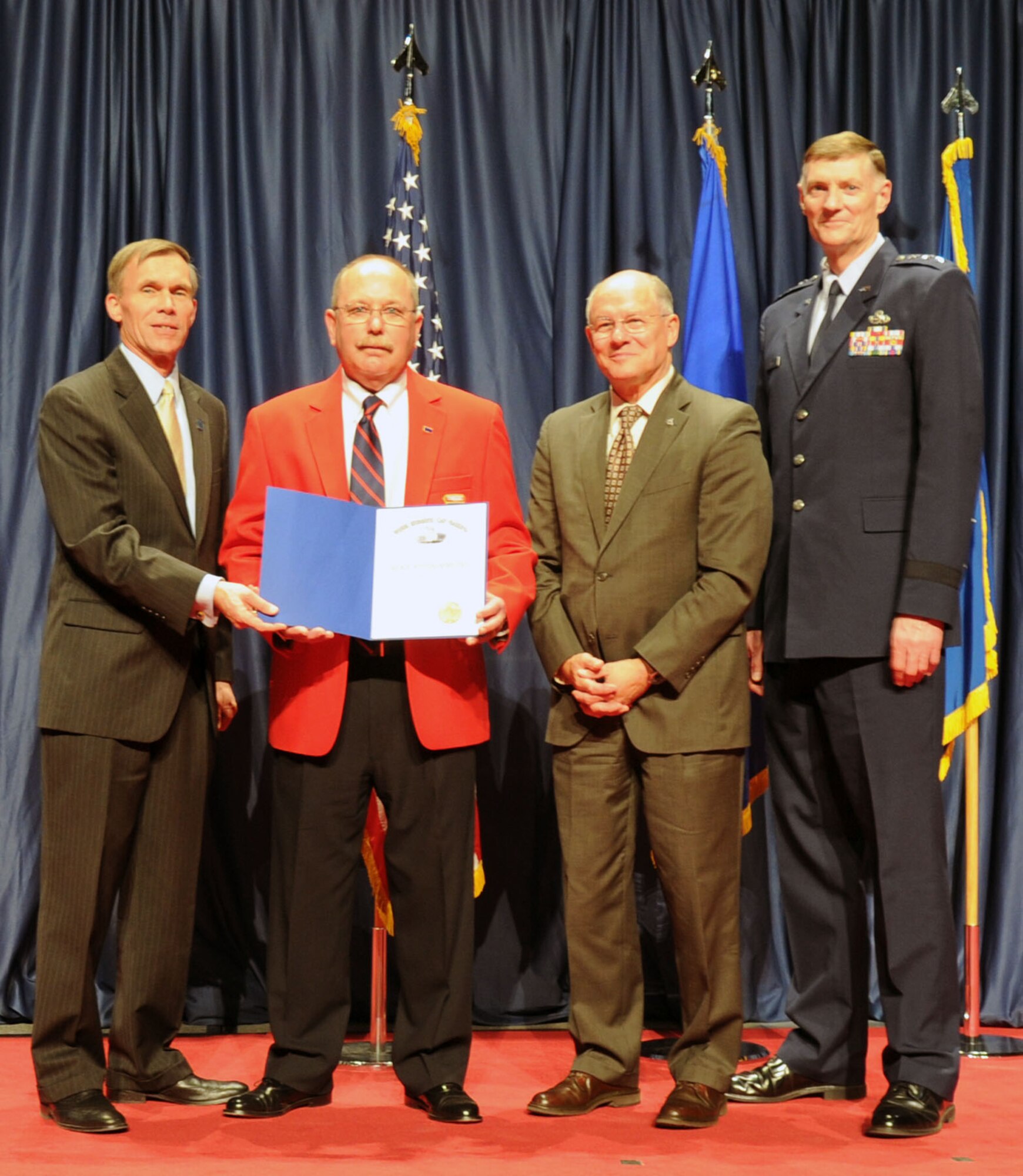 DAYTON, Ohio -- Mike Fitzsimmons (red jacket) received the 2013 Director’s Award for Volunteer of the Year for his dedication and excellence in serving the National Museum of the U.S. Air Force. (U.S. Air Force photo by Jeff Fisher)