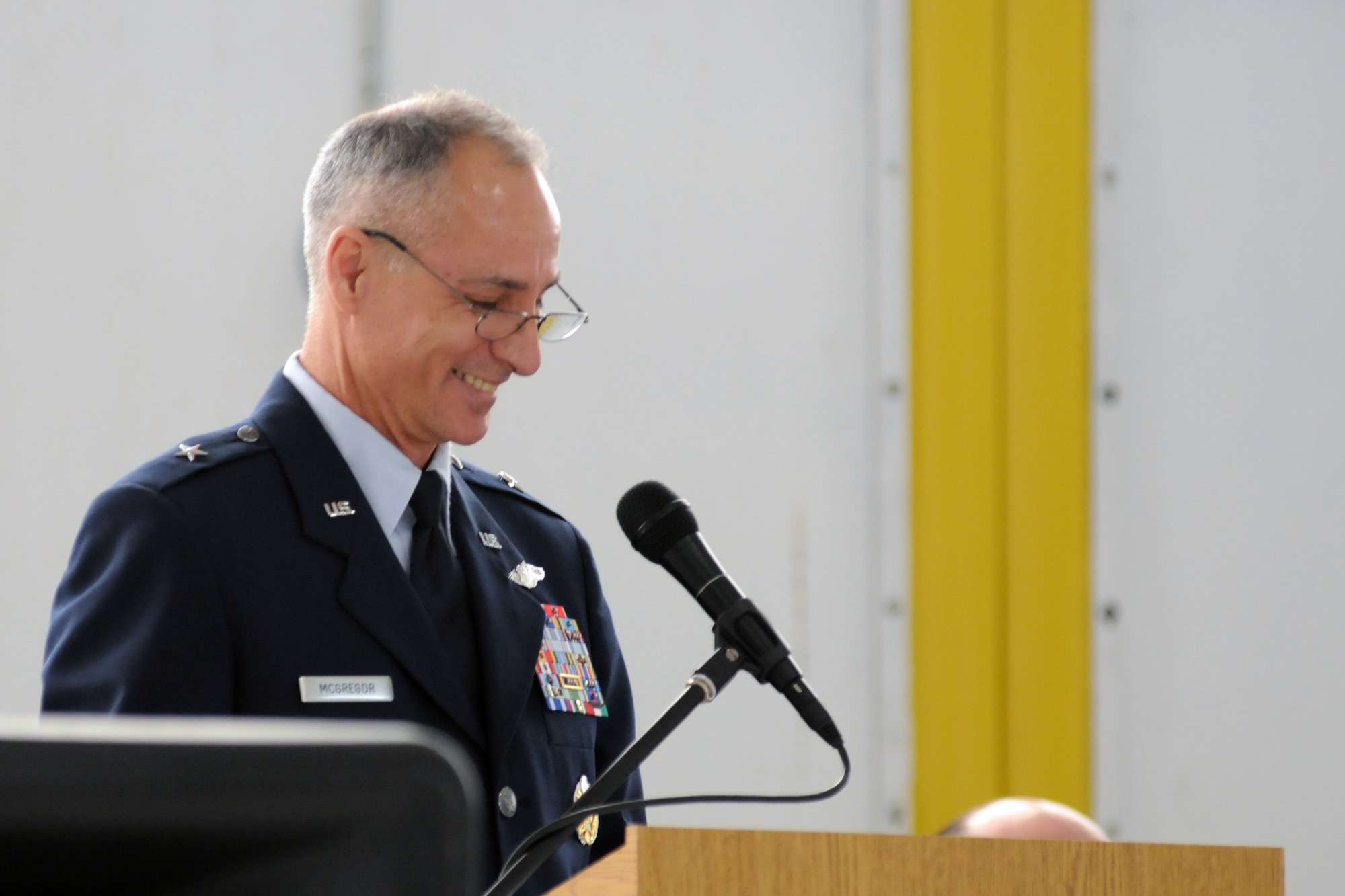 Brig. Gen. Udo K. McGregor, Military Deputy Director, Strategic Planning Deputy Chief of Staff, Strategic Plans and Programs and former 910th Airlift Wing commander, addresses the audience during the retirement ceremony of Chief Master Sgt. Troy Rhoades, 910th Airlift Wing Command Chief Master Sgt., here, April 5, 2014. Rhoades retired after 31 years of service in the Air Force Reserve. McGregor officiated the ceremony. U.S. Air Force photo/Tech. Sgt. Jim Brock.