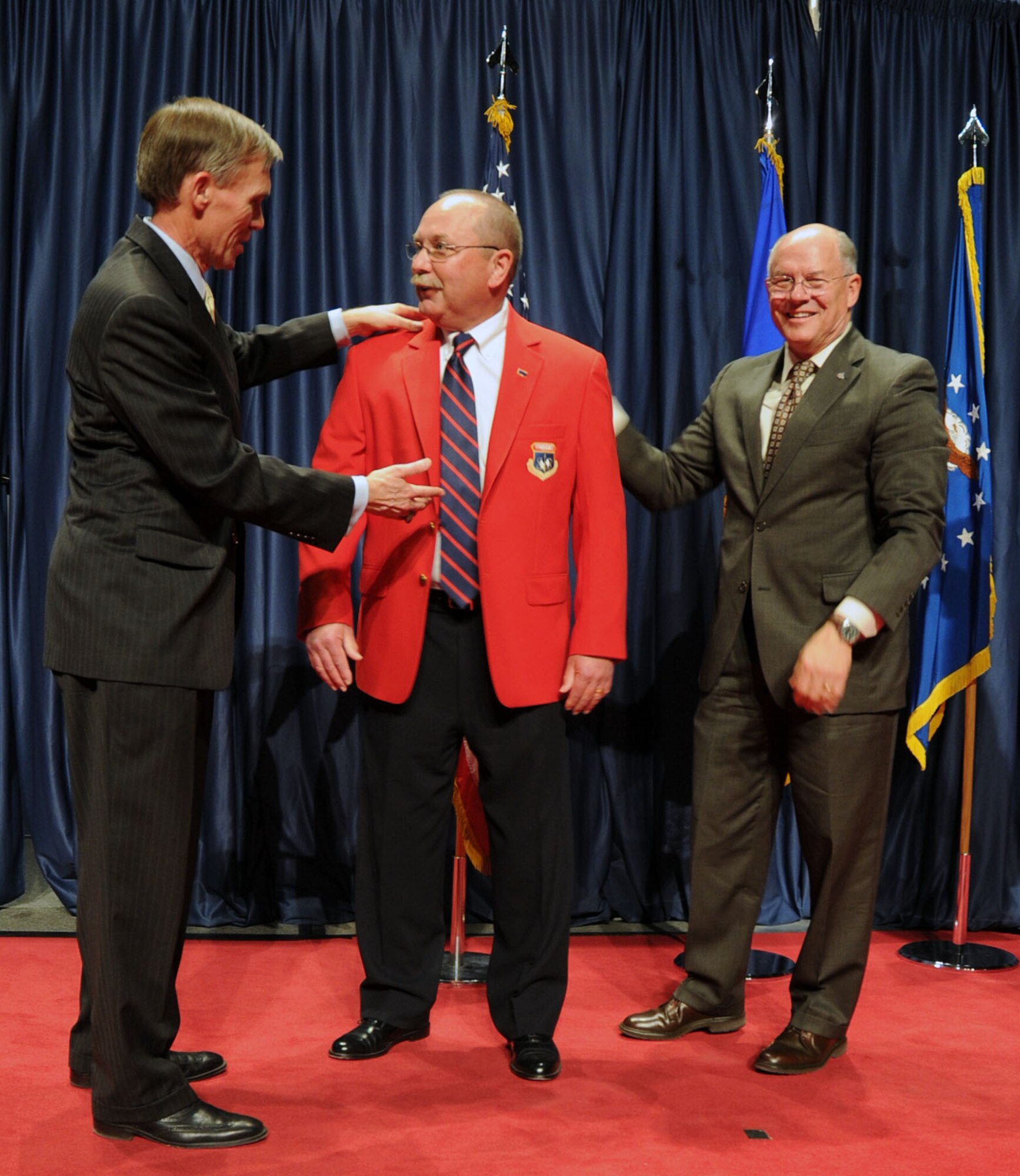 DAYTON, Ohio -- Mike Fitzsimmons (red jacket) received the 2013 Director’s Award for Volunteer of the Year for his dedication and excellence in serving the National Museum of the U.S. Air Force. (U.S. Air Force photo by Jeff Fisher)