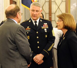 Sgt. Maj. of the Army Ray Chandler (center) and his wife Jeanne speak to Gary Leeling, general counsel for the Senate Armed Services Committee, during a break in the Personnel Subcommittee's hearing on Capitol Hill, April 9, 2014. Chandler and his service counterparts provided testimony related to quality of life issues. (U.S. Army photo by Sgt. Maj. Troy Falardeau/Released)