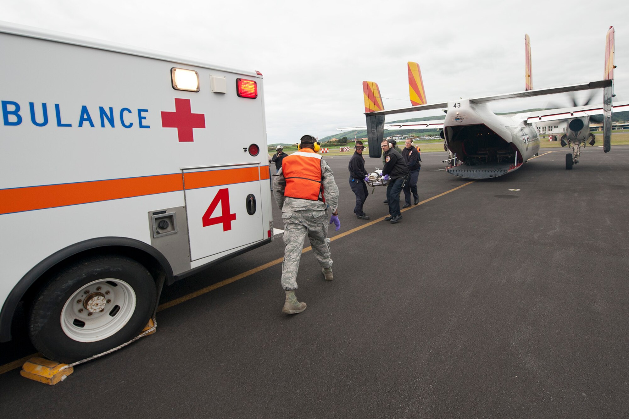 First responders from the 65th Medical Group and a U.S. Navy flight crew transport a patient during a medical evacuation mission here, April 11, Lajes Field, Azores.  A U.S. Navy Sailor required medical evacuation to Lajes Field due to acute abdominal pain.  First responders with the 65th Medical Group provided emergent care to the Sailor before the patient was transferred to a local hospital for care.  (U.S. Air Force photo by Tech. Sgt. Paul Villanueva II/Released)