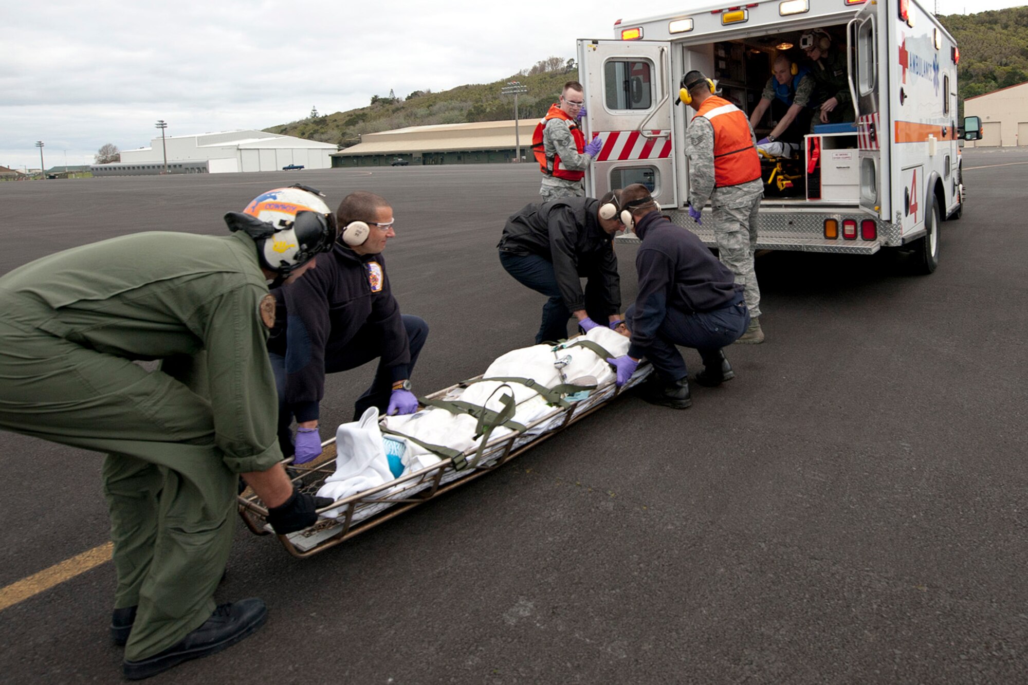 First responders from the 65th Medical Group and a U.S. Navy flight crew transport a patient during a medical evacuation mission here, April 11, Lajes Field, Azores.  A U.S. Navy Sailor required medical evacuation to Lajes Field due to acute abdominal pain.  First responders with the 65th Medical Group provided emergent care to the sailor before the patient was transferred to a local hospital for care.  (U.S. Air Force photo by Tech. Sgt. Paul Villanueva II/Released)