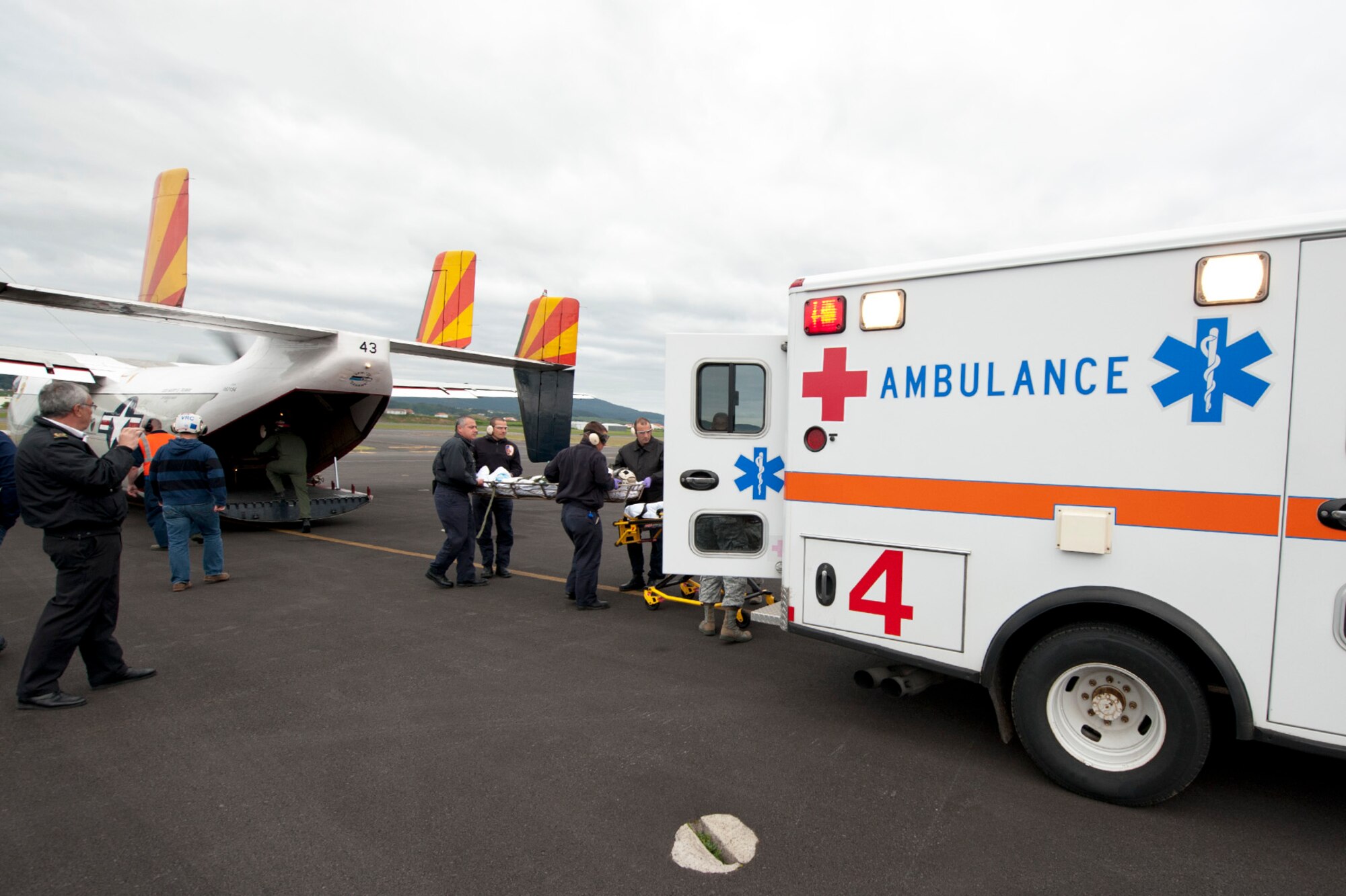 First responders from the 65th Medical Group and a U.S. Navy flight crew place a patient into an ambulance during a medical evacuation mission here, April 11, Lajes Field, Azores.  A U.S. Navy Sailor required medical evacuation to Lajes Field due to acute abdominal pain.  First responders with the 65th Medical Group provided emergent care to the sailor before the patient was transferred to a local hospital for care.  (U.S. Air Force photo by Tech. Sgt. Paul Villanueva II/Released)