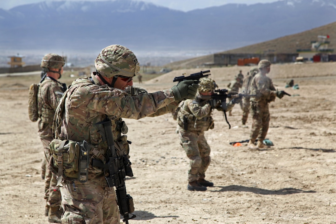 U.S. Army Maj. Gen. Stephen Townsend, foreground, fires his 9mm handgun ...