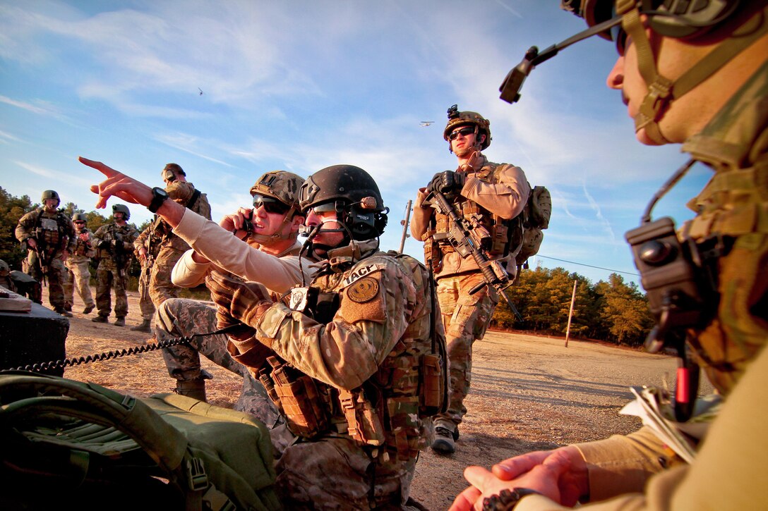 Airmen mark targets for a Marine Corps AH-1W Super Cobra helicopter during a training exercise on Fort Dix, N.J., April 10, 2014.  The helicopter crew is assigned to Marine Light Attack Helicopter Squadron 773.