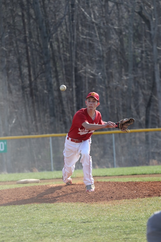 Treyton, a junior for the Quantico Middle/High School Warrior Baseball Team, delivers a pitch during a game against the Vendeens of the Holy Family Academy from Manassas, at George Hellwig Memorial Park in Manassas on April 9, 2014. The Warriors kept the lead the whole game but couldn't hold on in the last inning, losing 11-10.