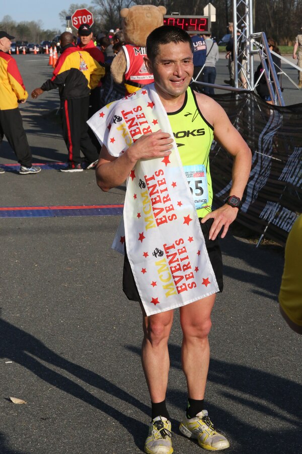 Steven Henry, from Odenton, Md., and a retired U.S. Army infantry soldier, pose at the finish line of the 2014 Marine Corps 17.75K at Prince William Forest Park in Prince William County on April 12, 2014. Henry completed the unique course in 1 hour, 4 minutes and 24 seconds.