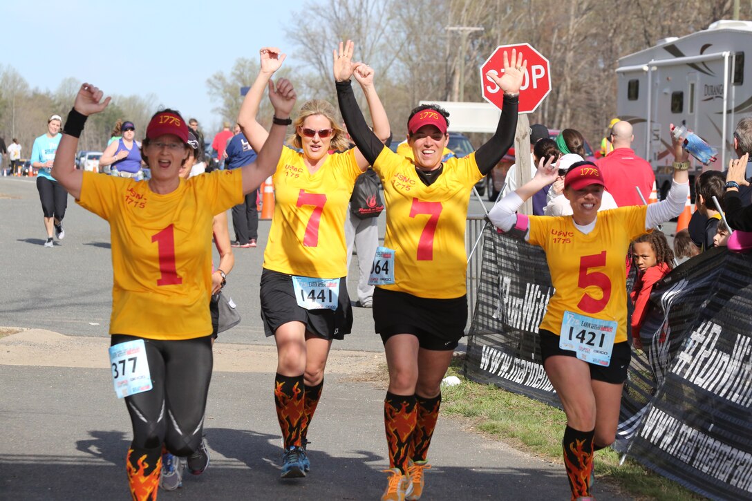 In 1775 formation, Abbey Bruckner, Jenny Dugan, Sarah Guthier and Betsy McKenna cross the finish line of the 2014 Marine Corps 17.75K at Prince William Forest Park in Prince William County, on April 12, 2014. The team maintained their formation for the entire race during their second year competing in the 17.75K race, finishing in 2 hours, 23 minutes and 42 seconds. 