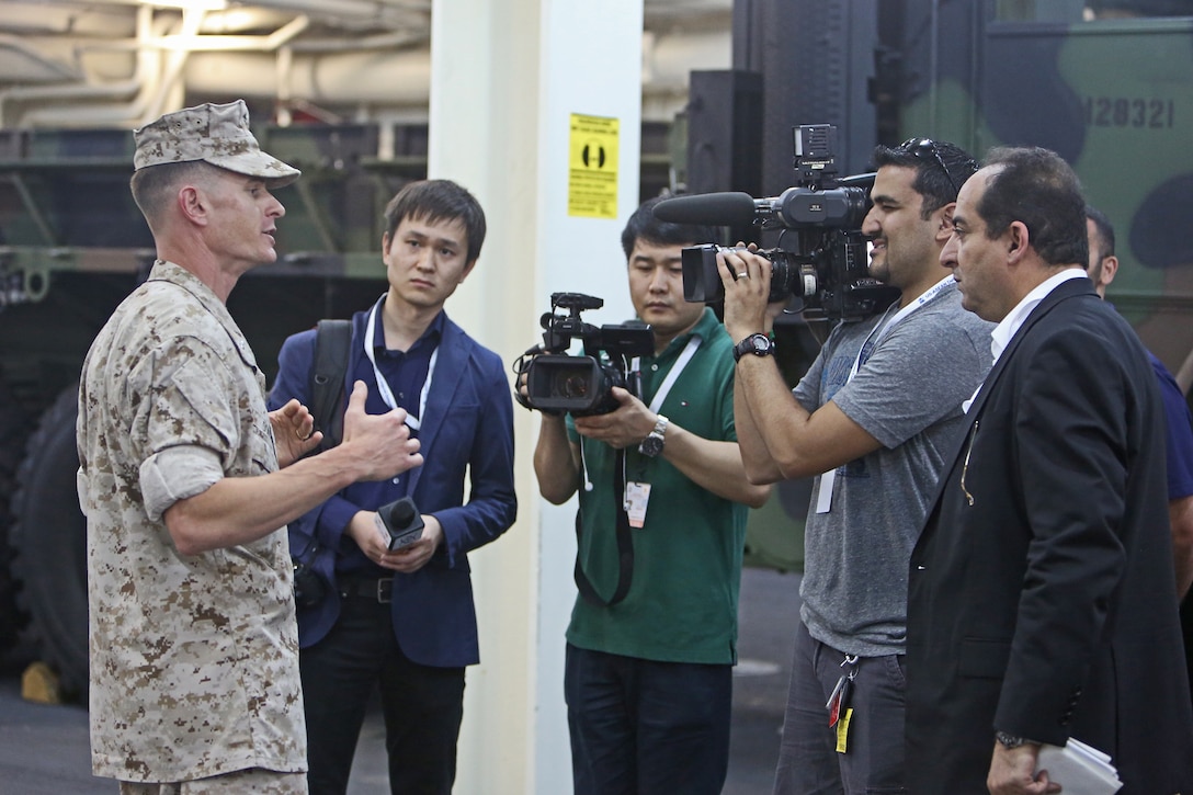 Lieutenant Col. Mark T. Donar, commanding officer, Special Purpose Marine Air-Ground Task Force Association of South East Asian Nations, briefs international media personnel on the MAGTF’s humanitarian aid and disaster relief capabilities during a static display aboard amphibious transport dock ship USS Anchorage (LPD 23) in support of the ASEAN conference held by U.S. Secretary of Defense Chuck Hagel in Hawaii, April 2, 2014. Delegates and media personnel, from 10 Southeast Asian countries, attended the exhibit to learn more about the Navy and Marine Corps’ aid capabilities. As subject matter experts with firsthand experience on their equipment, the Marines and sailors who participated were able to increase the international public’s understanding of what the Navy-Marine Corps team can do during disaster situations, and built rapport with foreign officials and militaries.
