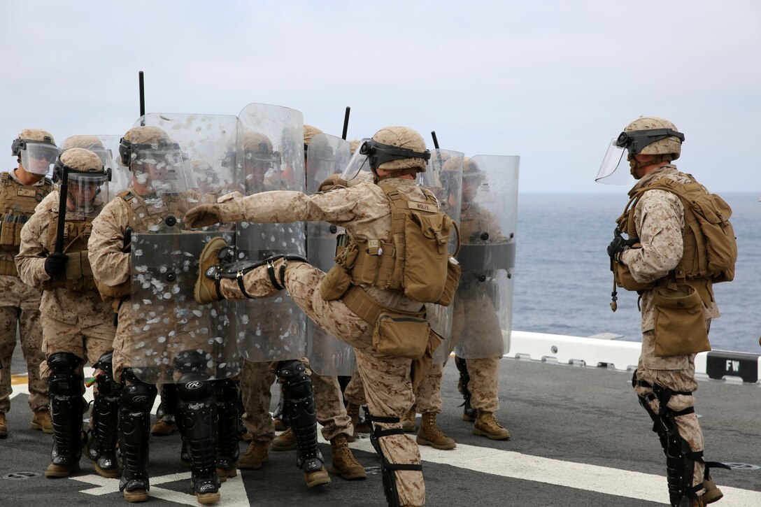 Marines with Fox Company, Battalion Landing Team 2nd Battalion, 1st Marines, 11th Marine Expeditionary Unit, practice riot control techniques aboard the USS Makin Island during Amphibious Squadron Marine Expeditionary Unit Integration Training (PMINT) off the coast of San Diego, April 11. PMINT introduces the 11th MEU to its Navy counterpart, Amphibious Squadron 5, and allows the unit to conduct live training at sea. (U.S. Marine Corps photo by Sgt. Melissa Wenger/Released)