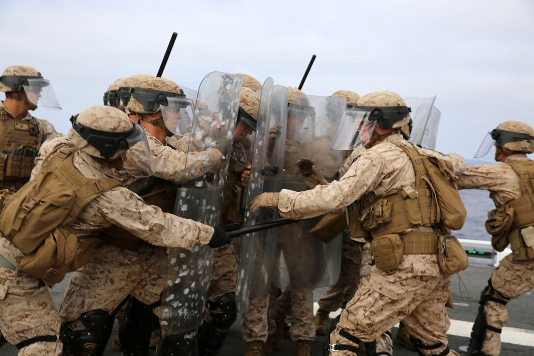 Marines with Fox Company, Battalion Landing Team 2nd Battalion, 1st Marines, 11th Marine Expeditionary Unit, practice riot control techniques aboard the USS Makin Island during Amphibious Squadron Marine Expeditionary Unit Integration Training (PMINT) off the coast of San Diego, April 11. PMINT introduces the 11th MEU to its Navy counterpart, Amphibious Squadron 5, and allows the unit to conduct live training at sea. (U.S. Marine Corps photo by Sgt. Melissa Wenger/Released)
