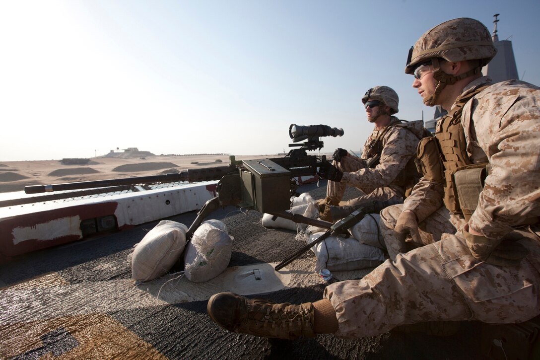 Lance Cpl. Daniel Leighty, front, an anti-tank missileman assigned to Battalion Landing Team (BLT) 1st Battalion, 6th Marine Regiment, 22nd Marine Expeditionary Unit (MEU), and machine gunner Pfc. Jordan Gemes, assigned to BLT 1/6, 22nd MEU, man an M2 .50-Caliber machine gun aboard the USS Mesa Verde (LPD 19) as it transits the Suez Canal. The 22nd MEU is deployed with the Bataan Amphibious Ready Group as a theater reserve and crisis response force throughout U.S. Central Command and the U.S. 5th Fleet area of responsibility.