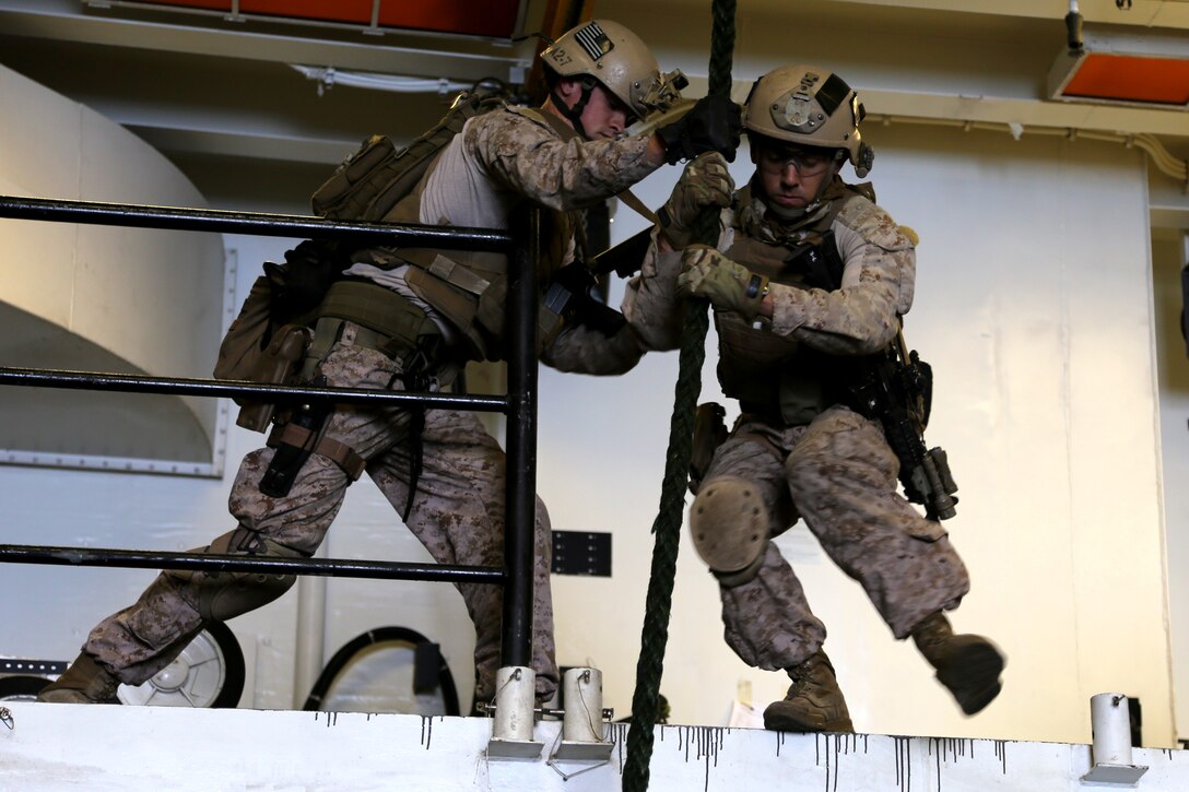 Marines with the Maritime Raid Force, 11th Marine Expeditionary Unit, execute fast rope drills aboard USS Makin Island a during Amphibious Squadron Marine Expeditionary Unit Integration Training (PMINT) off the coast of San Diego, April 11, 2014.  PMINT is a two-week predeployment training event focused on the combined capabilities of the MEU and Amphibious Ready Group (ARG), conducting amphibious operations, crisis response and limited contingency operations.  (U.S. Marine Corps photo by Lance Cpl. Laura Y. Raga/Released)