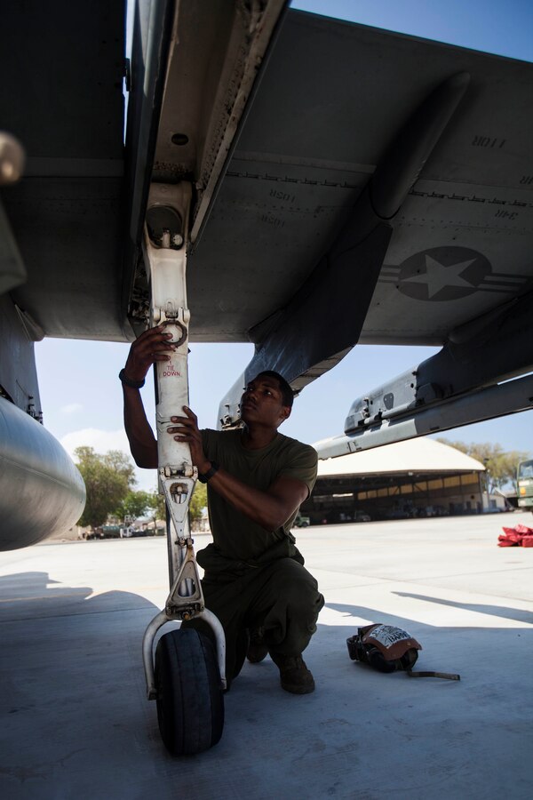 U.S. Marine Corps Cpl. Mike Banks, Marine Medium Tiltrotor Squadron (VMM) 263 (Reinforced), 22nd Marine Expeditionary Unit (MEU), powerline mechanic and native of Louisville, Miss., inspects the landing gear of an AV-8B Harrier after an air-to-air and air-to-ground combat exercise with French air force Mirage 2000 pilots at French Airbase 188. The 22nd MEU is deployed with the Bataan Amphibious Ready Group as a theater reserve and crisis response force throughout U.S. Central Command and the U.S. 5th Fleet area of responsibility.