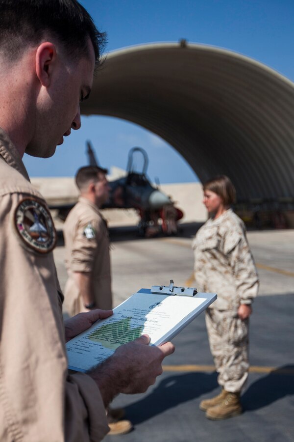 U.S. Marine Corps Maj. Jimmy Banton, Marine Medium Tiltrotor Squadron (VMM) 263 (Reinforced), 22nd Marine Expeditionary Unit (MEU), AV-8B Harrier pilot and native of Chesterfield, Va., reads the promotion warrant for U.S. Marine Corps Sgt. Heather Haun, VMM-263 (Rein.) powerline mechanic and native of Frenchtown, Mont., during a promotion ceremony at French Airbase 188. The 22nd MEU is deployed with the Bataan Amphibious Ready Group as a theater reserve and crisis response force throughout U.S. Central Command and the U.S. 5th Fleet area of responsibility.
