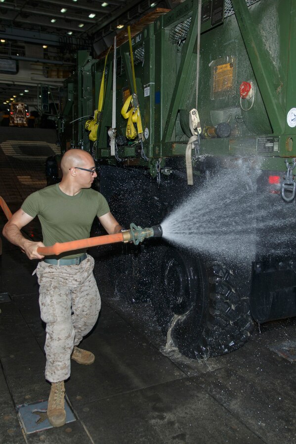 U.S. Marine Corps Lance Cpl. Dominique Jamatte, Combat Logistics Battalion 22, 22nd Marine Expeditionary Unit (MEU), operations clerk and native of Wilmington, Del., rinses a 7-ton truck as Marines and equipment from the MEU return to the USS Mesa Verde (LPD 19) after completing a bilateral exercise. The 22nd MEU is deployed with the Bataan Amphibious Ready Group as a theater reserve and crisis response force throughout U.S. Central Command and the U.S. 5th Fleet area of responsibility.