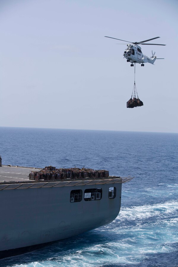A U.S. Merchant Marine SA 330 Puma helicopter carries supplies from the USNS Richard E. Byrd (T-AKE 4) to the USS Bataan (LHD5). The Bataan is the flagship of the Bataan Amphibious Ready Group and, with the embarked 22nd Marine Expeditionary Unit, is deployed in support of maritime security operations and theater security cooperation efforts in the U.S. 5th fleet area of responsibility.
