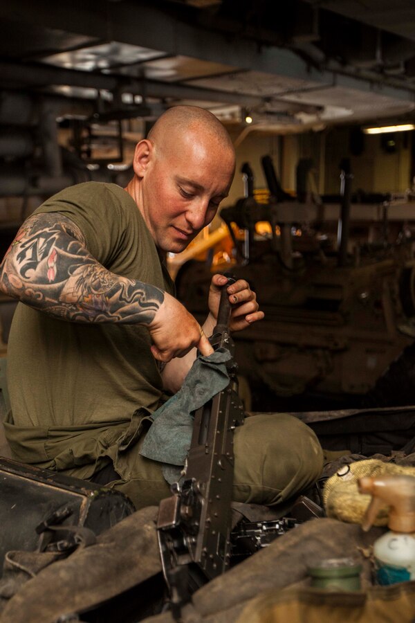 U.S. Marine Corps Sgt. John Galletta, Battalion Landing Team 1st Battalion, 6th Marine Regiment, 22nd Marine Expeditionary Unit (MEU), light armored vehicle (LAV) 25mm Bushmaster machine gunner and native of New York, cleans an M240B machine gun on an LAV aboard the USS Bataan (LHD 5). The 22nd MEU is deployed with the Bataan Amphibious Ready Group as a theater reserve and crisis response force throughout U.S. Central Command and the U.S. 5th Fleet area of responsibility.
