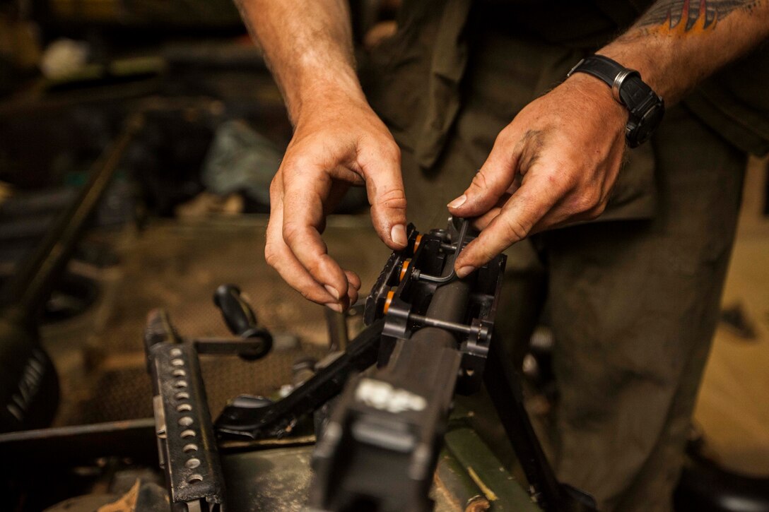 U.S. Marine Corps Sgt. John Moseley, Battalion Landing Team 1st Battalion, 6th Marine Regiment, 22nd Marine Expeditionary Unit (MEU), Light Armored Reconnaissance Company master gunner and native of Dallas, reassembles an M240B machine gun on an LAV aboard the USS Bataan (LHD 5). The 22nd MEU is deployed with the Bataan Amphibious Ready Group as a theater reserve and crisis response force throughout U.S. Central Command and the U.S. 5th Fleet area of responsibility.