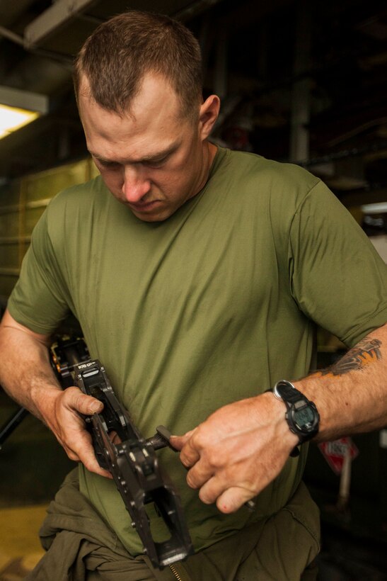 U.S. Marine Corps Sgt. John Moseley, Battalion Landing Team 1st Battalion, 6th Marine Regiment, 22nd Marine Expeditionary Unit (MEU), Light Armored Reconnaissance Company master gunner and native of Dallas, reassembles an M240B machine gun on an LAV aboard the USS Bataan (LHD 5). The 22nd MEU is deployed with the Bataan Amphibious Ready Group as a theater reserve and crisis response force throughout U.S. Central Command and the U.S. 5th Fleet area of responsibility.