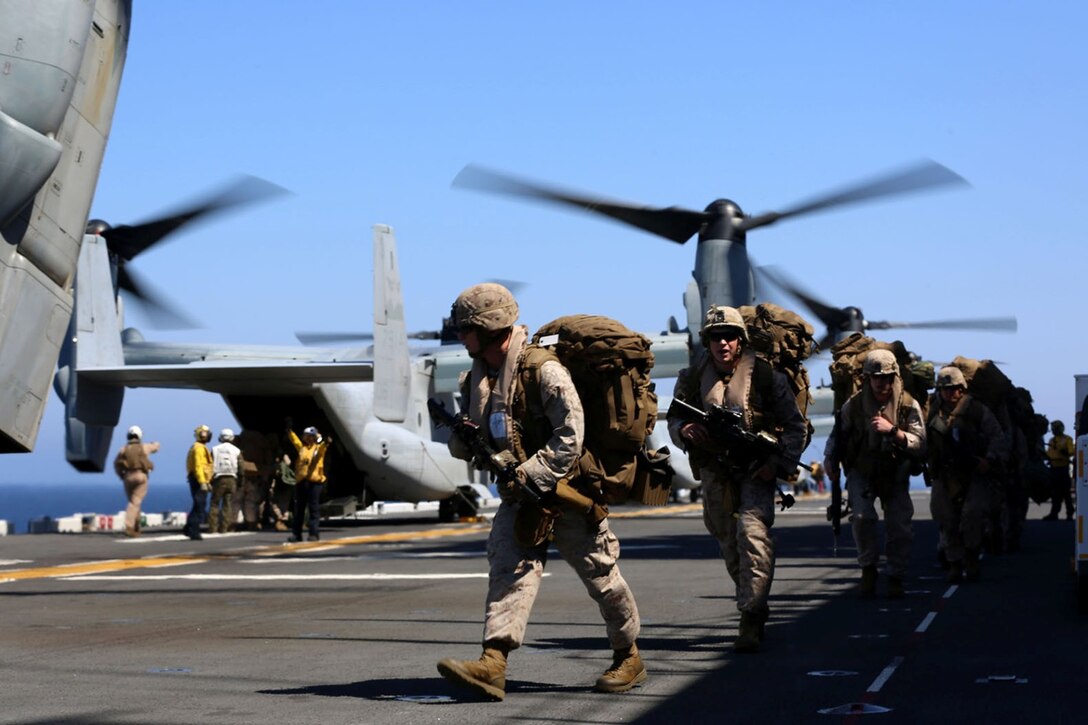 Marines with Fox Company, Battalion Landing Team 2nd Battalion, 1st Marines, 11th Marine Expeditionary Unit, board an MV-22B Osprey with Marine Medium Tiltrotor Squadron 163 (Reinforced), 11th MEU, on the flight deck of the USS Makin Island during Amphibious Squadron Marine Expeditionary Unit Integration Training (PMINT) off the coast of San Diego, April 14. The 11th MEU and its counterpart, Amphibious Squadron 5, execute various sea-based missions as part of PMINT. (U.S. Marine Corps photo by Sgt. Melissa Wenger/Released)