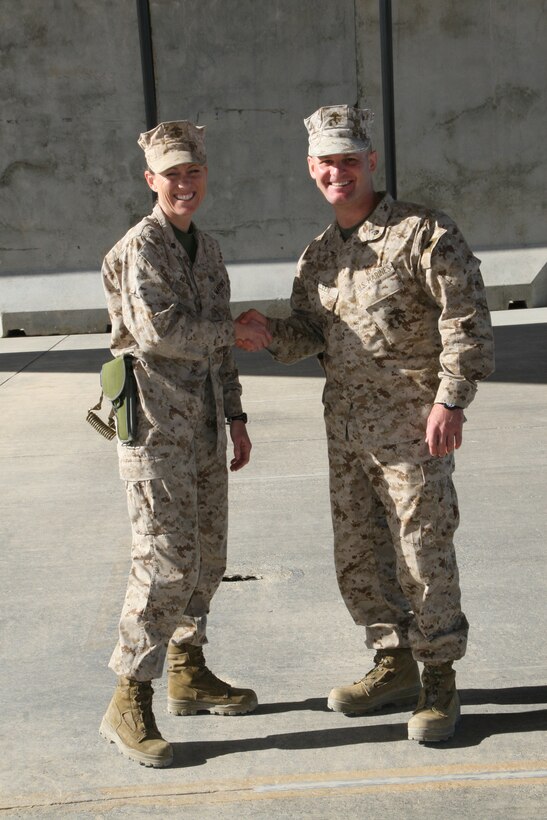 Lieutenant Col. Sean C. Killeen, right, commanding officer, Marine Wing Support Squadron 274, shakes hands with Lt. Col. Maura M. Hennigan, commanding officer, MWSS-372, after a transfer of authority ceremony held aboard Camp Bastion, Afghanistan, April 7, 2014. Marine Wing Support Squadron 372 was replaced by MWSS-274, which took on the responsibility of providing ground support for the aviation combat element with Regional Command (Southwest).