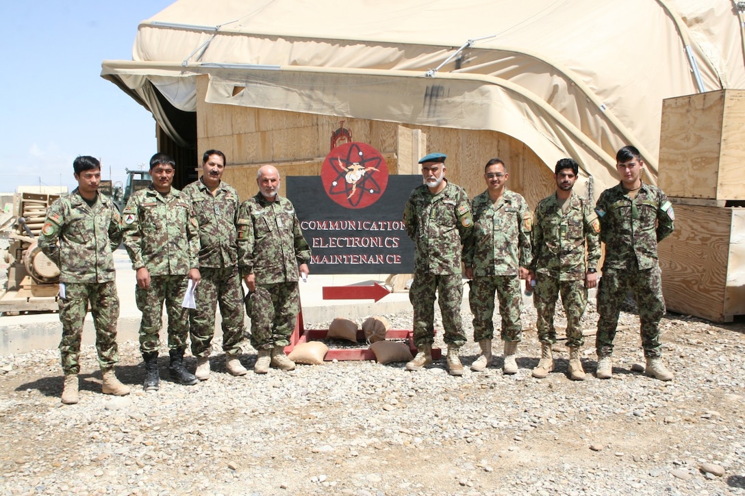 Afghan National Army soldiers with the 215th Corps pause for a picture following the curriculum review for the upcoming Communication Electronics Maintenance Course aboard Camp Leatherneck, Helmand province, Afghanistan, April 6, 2014. The course is scheduled to begin this month.