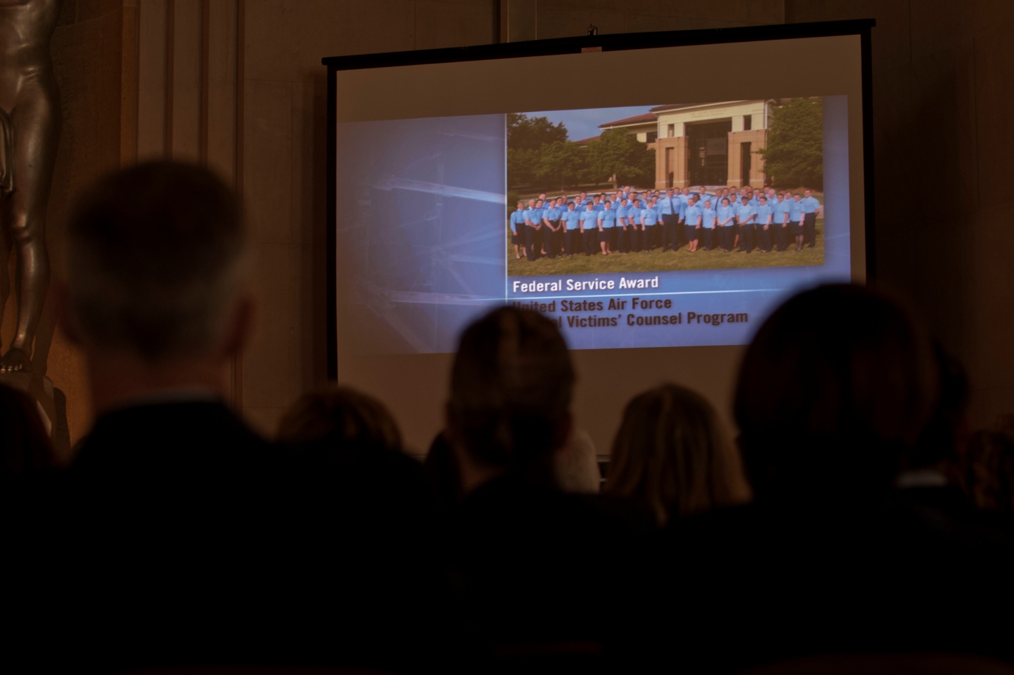 Members of the Air Force Judge Advocate General’s Corp watch their award video during the 2014 Justice Department’s National Crime Victims’ Rights Service Awards ceremony April 9, 2014 at the Department of Justice, Washington D.C.  The JAG Corps received the Federal Service Award for their work on their Special Victims’ Counsel program. (U.S. Air Force photo/Staff Sgt. Carlin Leslie)