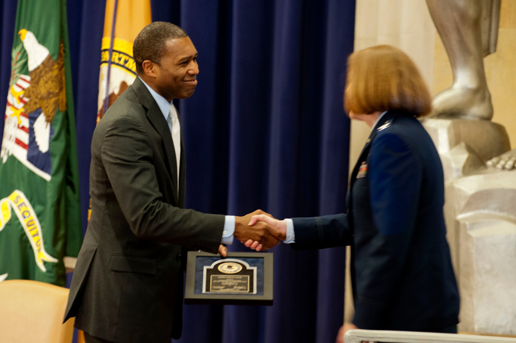 Tony West (left) presents Col. Dawn Hankins with the Federal Service Award during the 2014 Justice Department’s National Crime Victims’ Rights Service Awards ceremony, April 9, 2014, at the Department of Justice, Washington D.C. West is the associate attorney general of the United States. Hawkins is the chief of the Air Force Special Victims’ Counsel Program  (U.S. Air Force photo/Staff Sgt. Carlin Leslie)