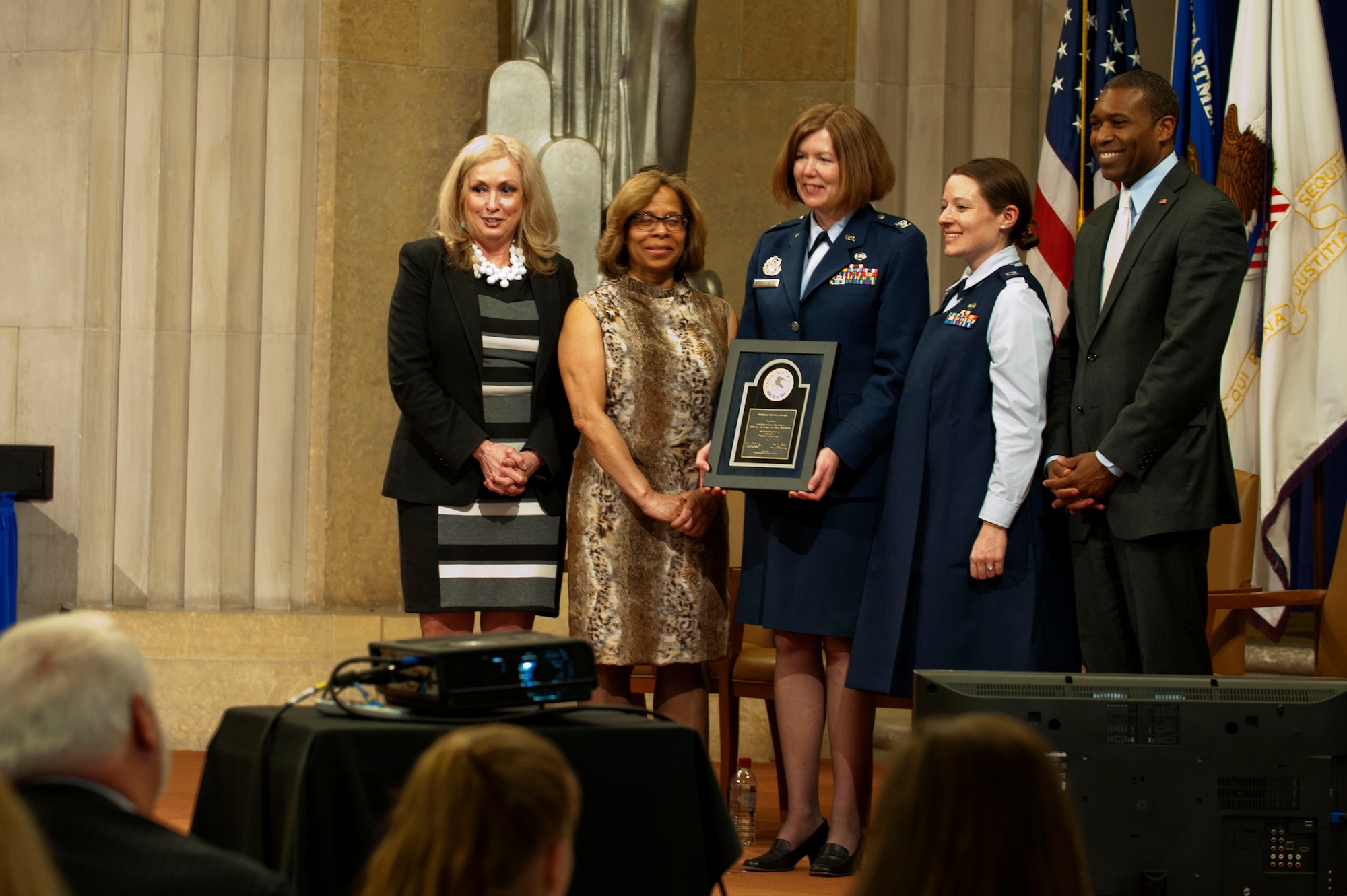 Members of the Air Force Judge Advocate General’s Corps pose for an awards photo after receiving the Federal Service Award from the Department of Justice, during the 2014 Justice Department’s National Crime Victims’ Rights Service Awards ceremony, April 9, 2014, at the Department of Justice, Washington D.C. The JAG Corps received the  Award for the implementation and administration of the Special Victims’ Counsel program.  (U.S. Air Force photo/Staff Sgt. Carlin Leslie)