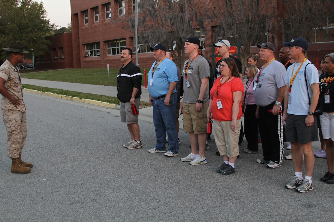 U.S. Marine Corps Staff Sgt. David R. McFadden, a drill instructor at Marine Corps Recruit Depot Parris Island, S.C., explains the position of attention during Recruiting Station Detroit’s Educator Workshop at MCRD Parris Island April 3, 2014. The Educator Workshop is an annual program conducted by recruiting stations across the United States with the goal of enhancing educator’s knowledge about the Marine Corps for when they advise their students about possible career paths. (U.S. Marine Corps photo by Cpl. Tyler Birky/Released)
