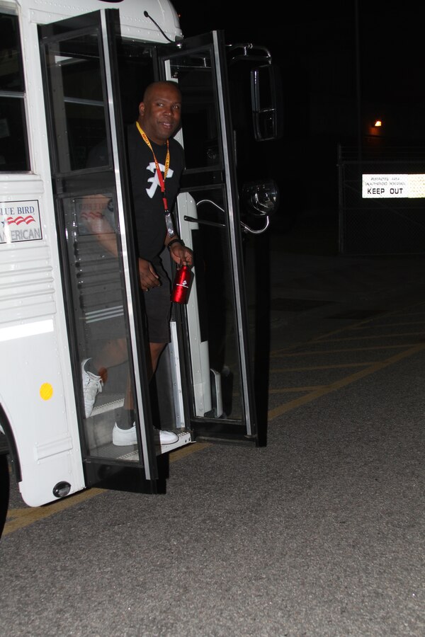 Victor Holman, an English teacher at Franklin High School in Canton, Mich., hurries off a bus to stand on the yellow footprints during Recruiting Station Detroit’s Educator Workshop at Marine Corps Recruit Depot Parris Island, S.C. April 3, 2014. The Educator Workshop is an annual program conducted by recruiting stations across the United States with the goal of enhancing educator’s knowledge about the Marine Corps for when they advise their students about possible career paths. (U.S. Marine Corps photo by Cpl. Tyler Birky/Released)