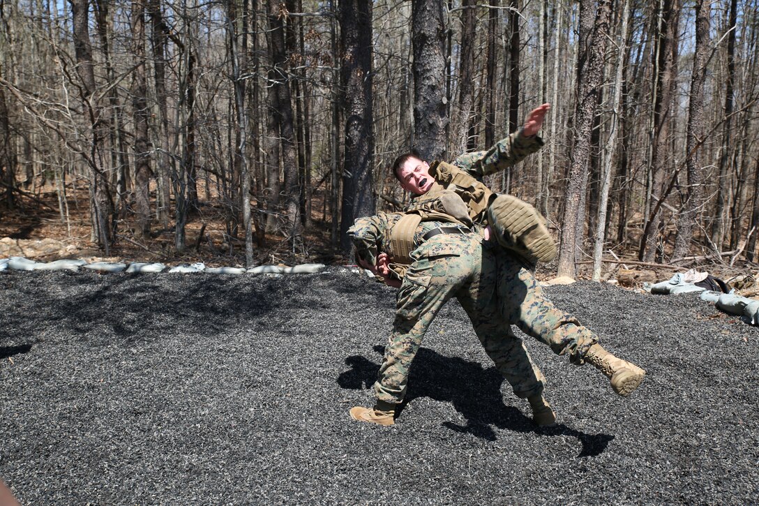 Cpl. Andrew Whitten, a field radio operator with Logistics Support Group on Camp Barrett and member of the communications platoon, gets hip-thrown by Sgt. Casey Yelton, a field radio operator with Logistics Support Group on Camp Barrett and member of the communications platoon, at the Marine Corps Martial Arts Program station on Camp Barrett on April 10, 2014. They were participating in the Logistics Support Group squad competition.