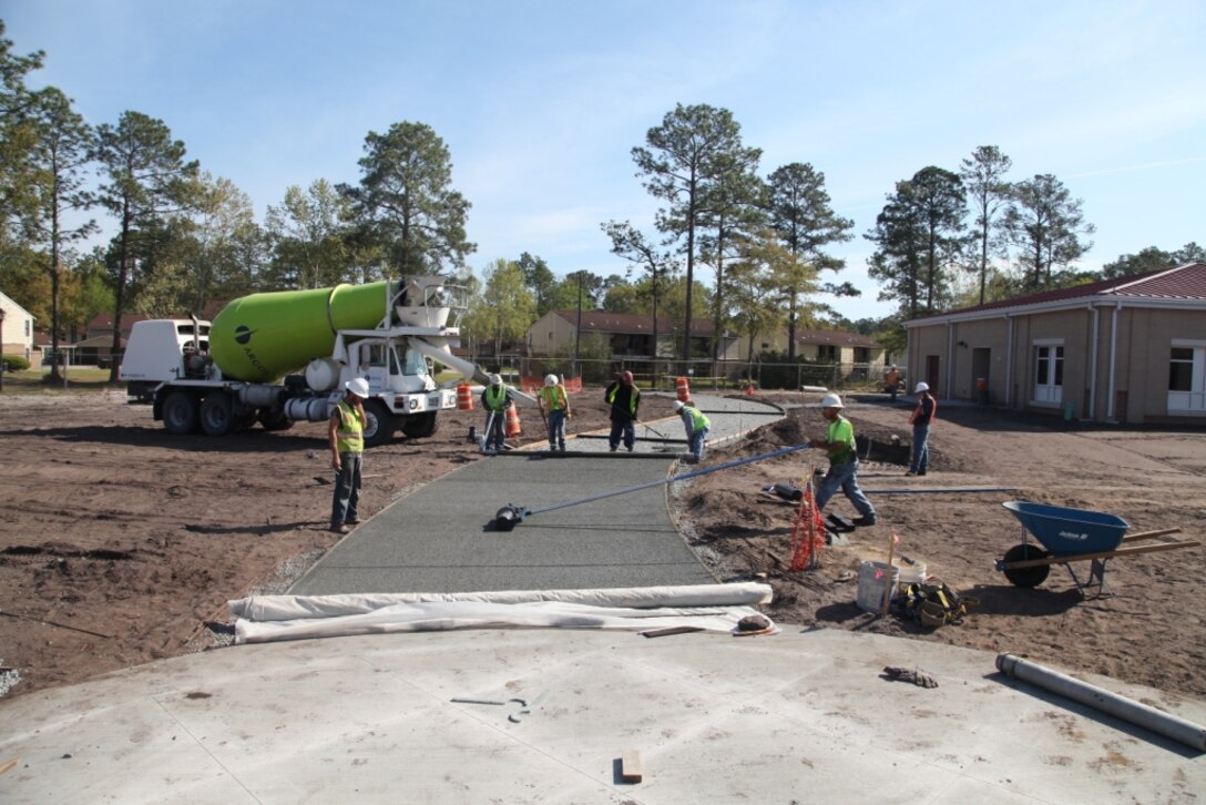 Workers build sidewalks at the new Murray Elementary School using environmentally-sustainable pervious material. The sidewalks will allows water to pass directly through them, thus reducing runoff from the site and allowing groundwater to recharge. 