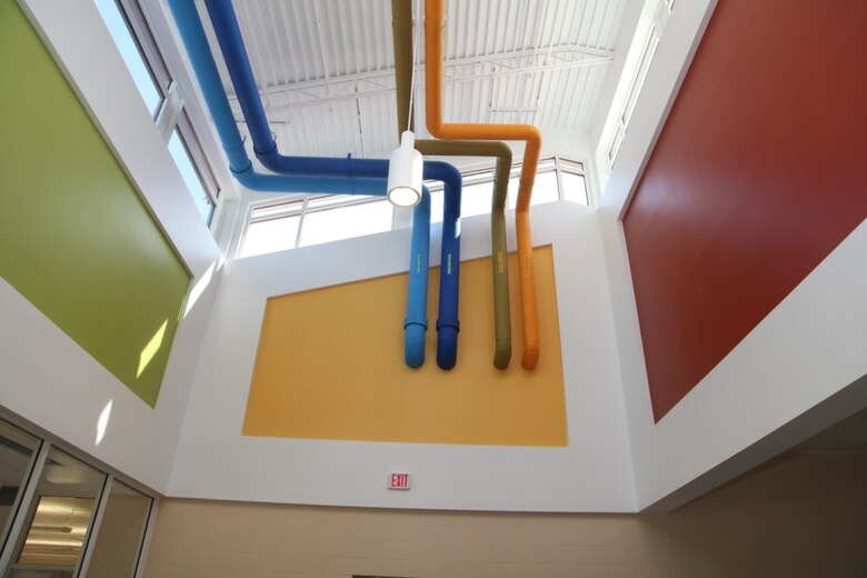 Brightly painted pipes show children how hot and cold water circulate in and out of the building at the new Murray Elementary School. The design functions as a teaching aid for children to learn about environmentally-sustainable building practices. 