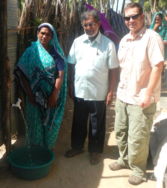 Mike MacMillan, project manager in the Environmental Special Projects Branch, poses with a newly installed water spigot near Puttalam, Sri Lanka. The U.S. Army Corps of Engineers – Alaska District, U.S. Pacific Command and the U.S. Agency for International Aid are coordinating an effort to connect 371 family households to the town’s water supply.