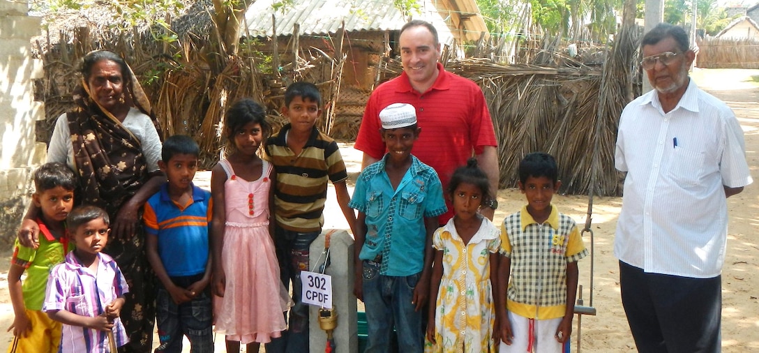 Col. Christopher Lestochi, district commander, poses with a family benefiting from the Puttalam water project. The U.S. Army Corps of Engineers?" Alaska District, U.S. Pacific Command and the U.S. Agency for International Aid are coordinating an effort to connect 371 family households to the town's water supply.