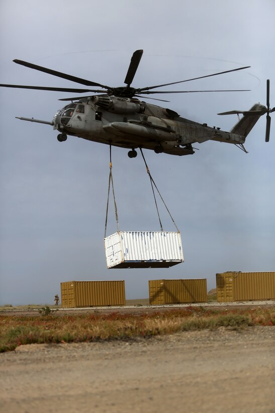 A CH-53E Super Stallion with Medium Tiltrotor Squadron 163 (Reinforced), 11th Marine Expeditionary Unit lifts cargo during a helicopter support team mission as part of Amphibious Squadron Marine Expeditionary Unit Integration Training (PMINT) on San Clemente Island, Calif., April 10, 2014.  PMINT is a two-week predeployment training event focused on the combined capabilities of the 11th MEU and Makin Island Amphibious Ready Group, conducting amphibious operations, crisis response, and limited contingency operations.  (U.S. Marine Corps photo by Lance Cpl. Evan R. White/Released)