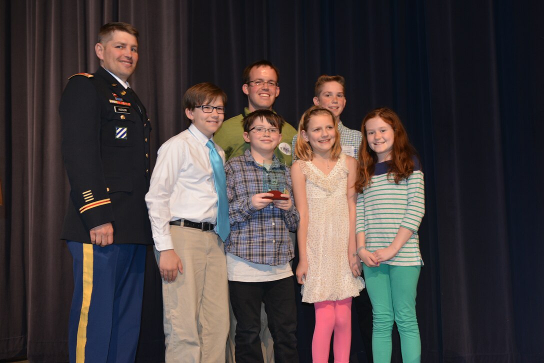 Lt. Col. John L. Hudson, Nashville District commander, (left) recognized students and faculty from the Jack Anderson Elementary school, and presented a glass trophy and certificate to them for their STEM project on Wind Energy and Hydropower at the Volunteer State Community College, April 11, 2014.