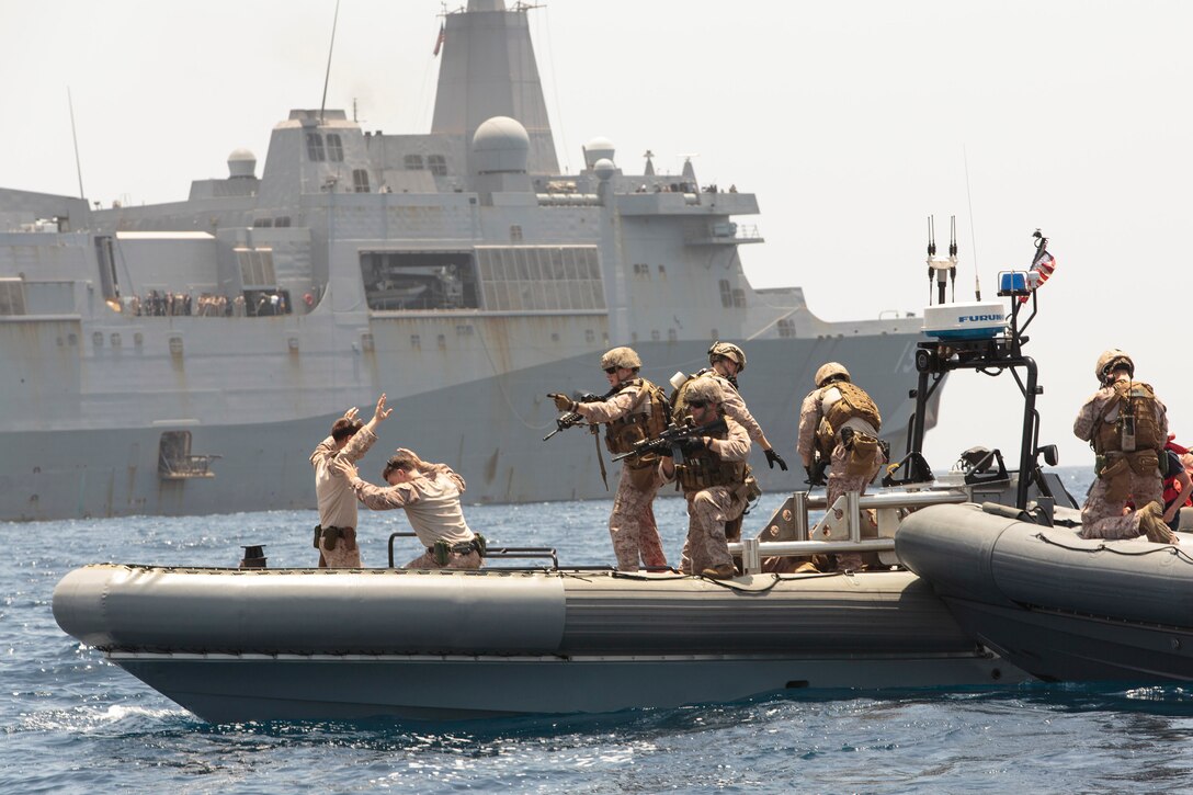 Reconnaissance Marines with Battalion Landing Team 1st Battalion, 6th Marine Regiment, 22nd Marine Expeditionary Unit (MEU), secure a simulated suspect civilian craft during maritime interdiction operations training, next to the USS Mesa Verde (LPD 19). The 22nd MEU is deployed with the Bataan Amphibious Ready Group as a theater reserve and crisis response force throughout U.S. Central Command and the U.S. 5th Fleet area of responsibility.