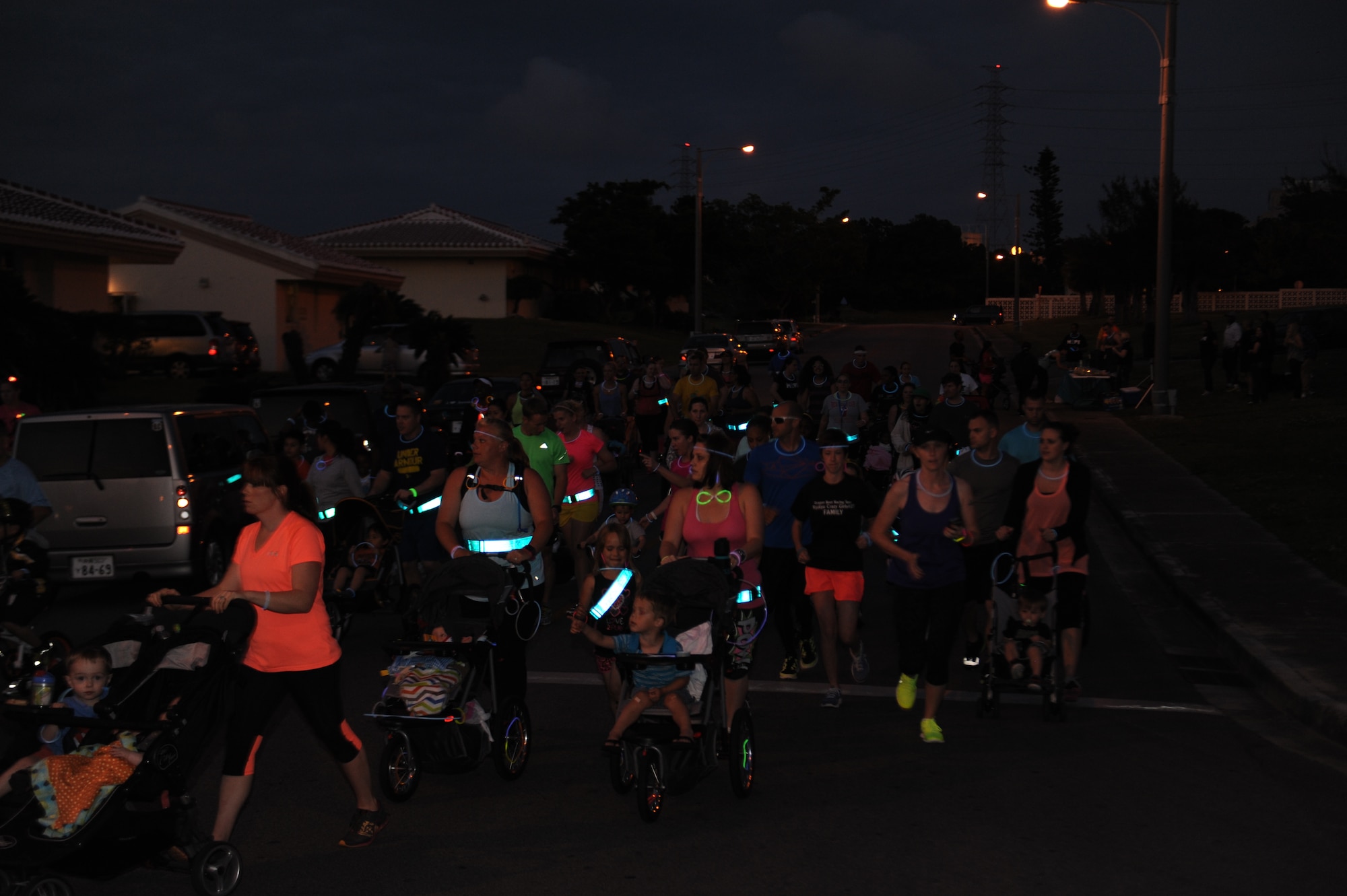 Members of Team Kadena participate in a 5k glow run as part of Sexual Assault Awareness Month on Kadena Air Base, Japan, April 12, 2014.  The glow run was one of the many events organized by Kadena’s SAPR program to raise public support during Sexual Assault Awareness Month. (U.S. Air Force photo by Airman 1st Class Zackary A. Henry)