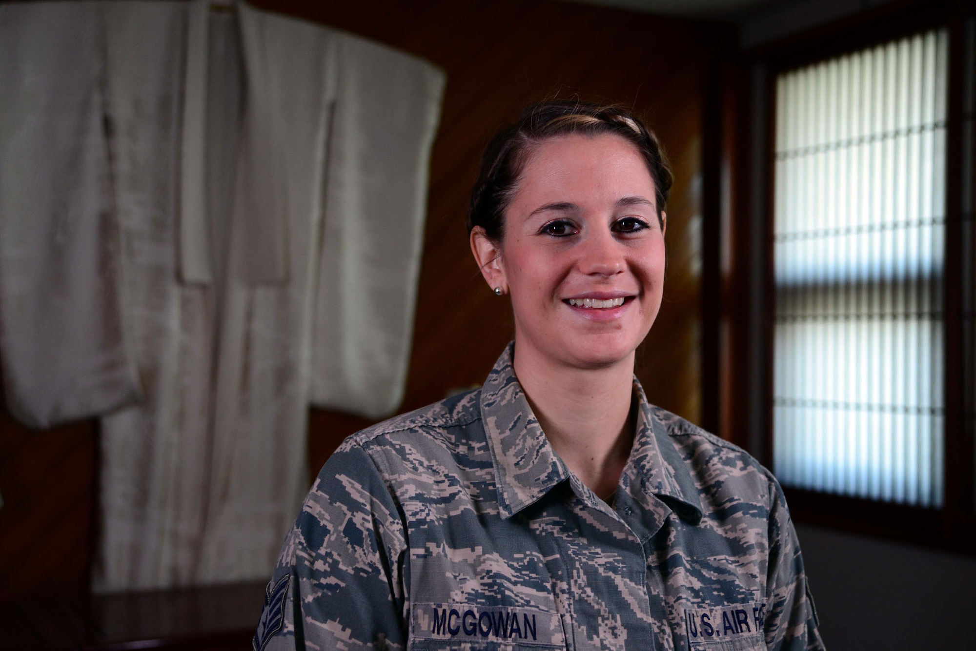 U.S. Air Force Staff Sgt. Sarah McGowan, 35th Fighter Wing Staff Protocol noncommissioned officer in charge, smiles for a photo at the 35 FW distinguished visitors lounge at Misawa Air Base, Japan, April 16, 2014. McGowan was named Misawa’s Wild Weasel of the Week, which recognizes a member of the 35 FW based on superior performance, outstanding work ethic and overall conduct and good discipline. McGowan coordinates and supports official functions, special events, retirement ceremonies and more. (U.S. Air Force photo/Senior Airman Derek VanHorn)