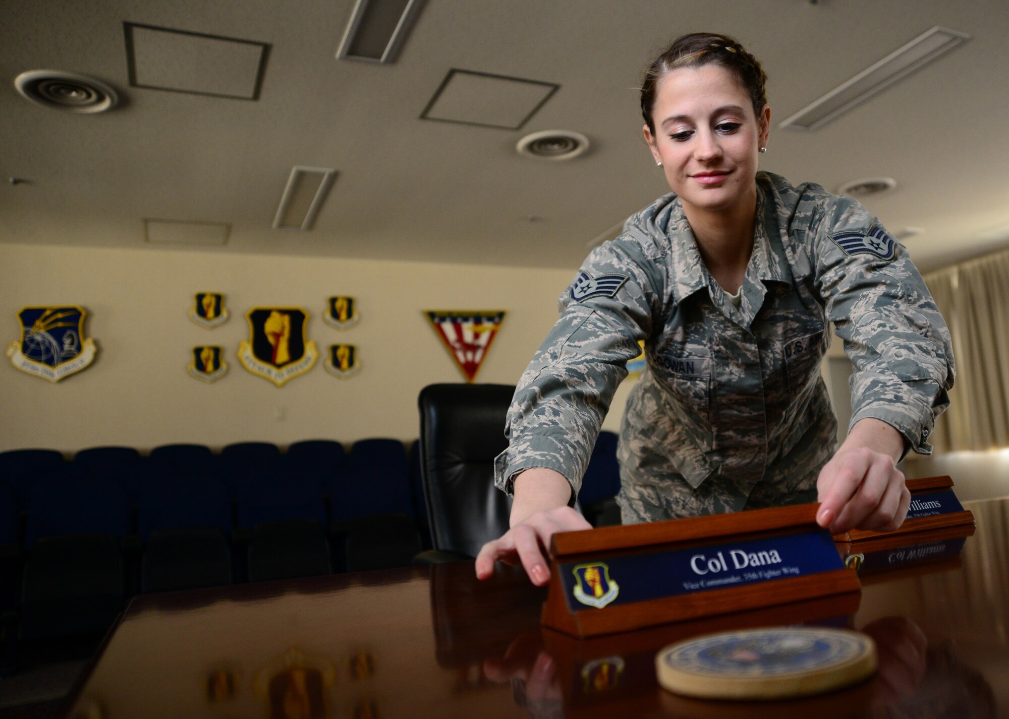 U.S. Air Force Staff Sgt. Sarah McGowan, 35th Fighter Wing Staff Protocol noncommissioned officer in charge, prepares the 35 FW headquarters conference room for a meeting at Misawa Air Base, Japan, April 15, 2014. McGowan’s regular responsibilities include supporting distinguished visitor ceremonies and events hosted by the 35 FW. (U.S. Air Force photo/Senior Airman Derek VanHorn)