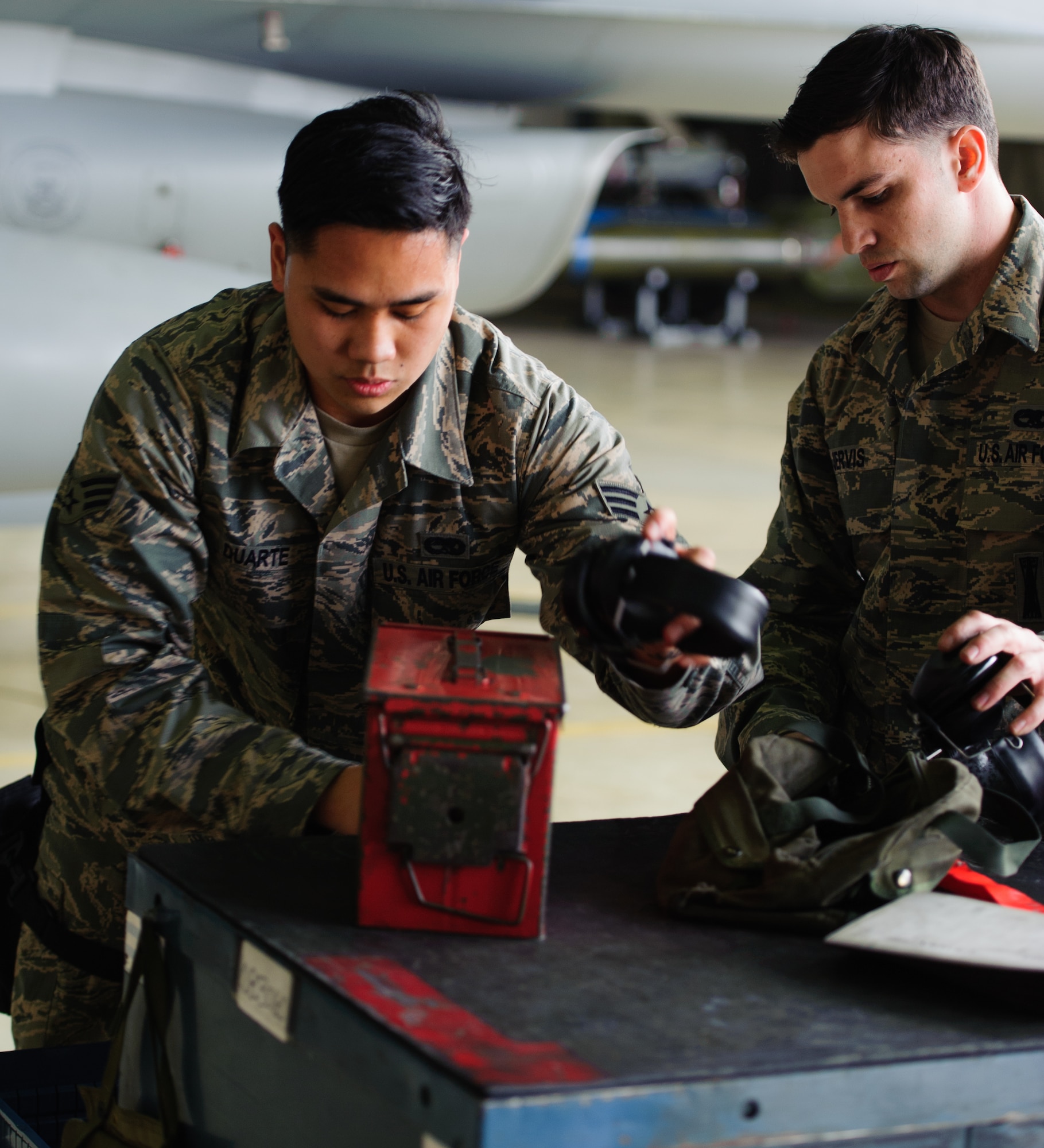Senior Airman Ryanted Duarte, 80th Aircraft Maintenance Unit load crew member, left, and Senior Airman Stephen Jervis, 80th AMU load crew member, right, clean their tool kit after loading a missile and bomb during the 1st Quarter Load Competition at Kunsan Air Base, Republic of Korea, Apr. 11, 2014. The 8th Maintenance Group weapons standardization team hosted the competition to showcase the skills and abilities of each AMU squadron as well as to promote espirit de corps. (U.S. Air Force photo by Senior Airman Armando A. Schwier-Morales/Released)