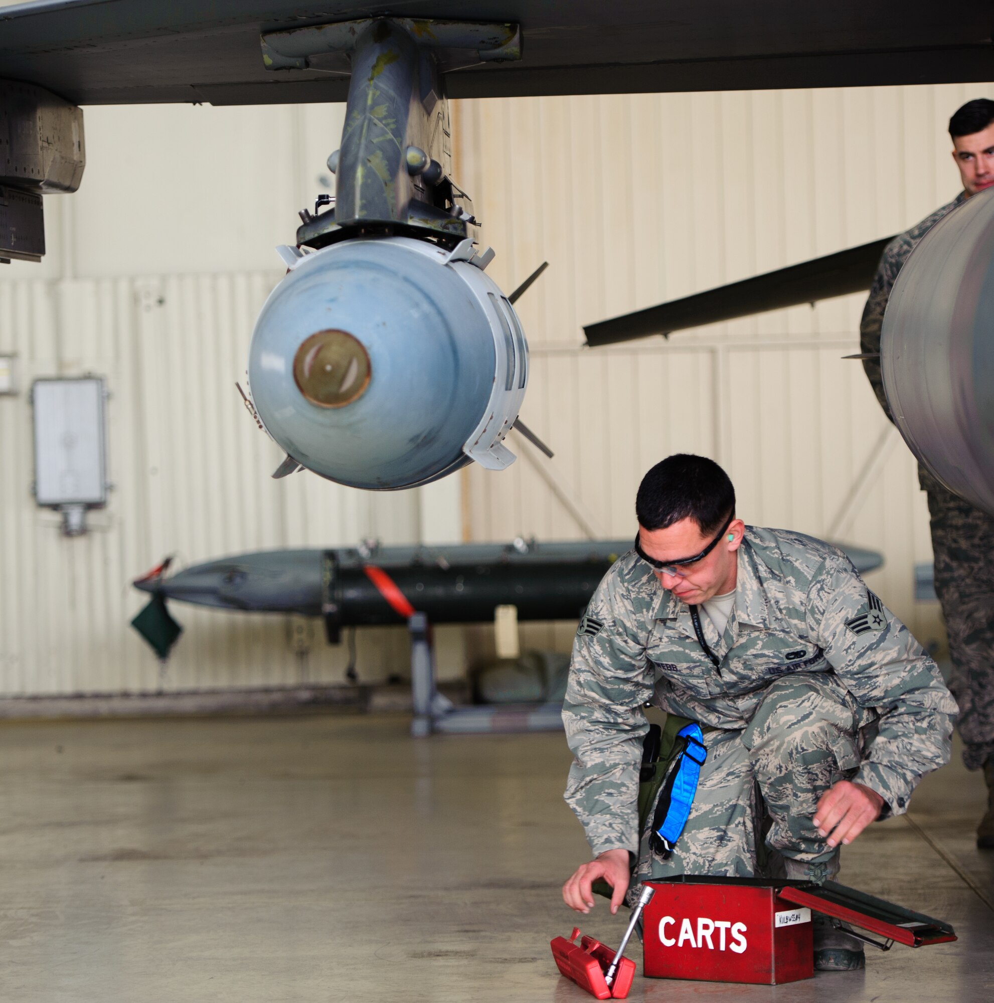 Senior Airman Christopher Webb, 35th Aircraft Maintenance Unit load crew member, finishes loading a guided bomb unit during the 1st Quarter Load Competition at Kunsan Air Base, Republic of Korea, Apr. 11, 2014. The 8th Maintenance Group weapons standardization team hosted the competition to showcase the skills and abilities of each AMU squadron as well as to promote espirit de corps. (U.S. Air Force photo by Senior Airman Armando A. Schwier-Morales/Released)