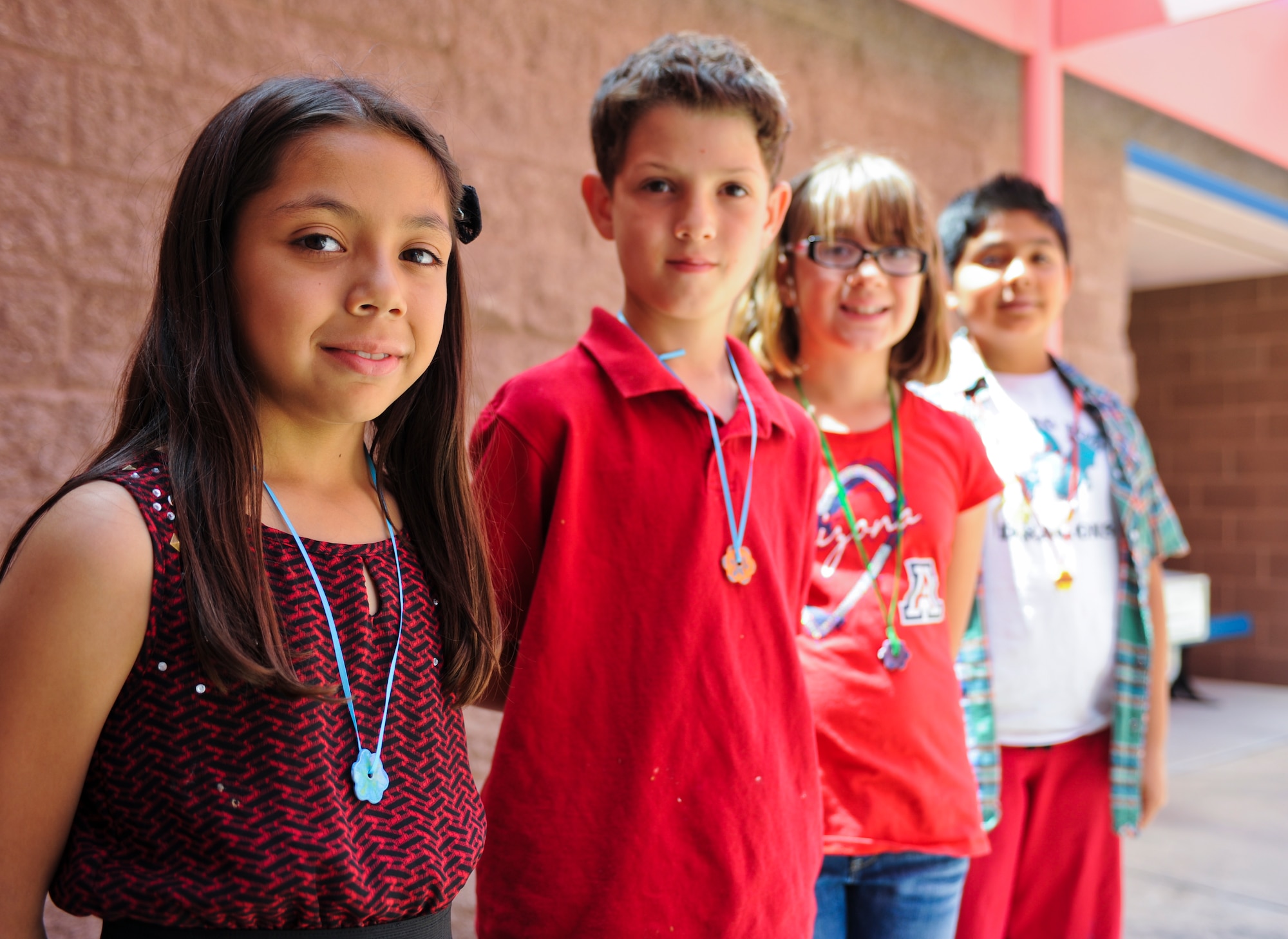Soleng Tom Elementary School students wear “Be Kind” program coined necklaces from the Ben’s Bells Project in Tucson, Ariz., April 10, 2014. Ben’s Bells Foundation has been active for more than 10 years and has placed more than 40,000 necklaces in public places.(U.S. Air Force photo by Senior Airman Sivan Veazie/Released)