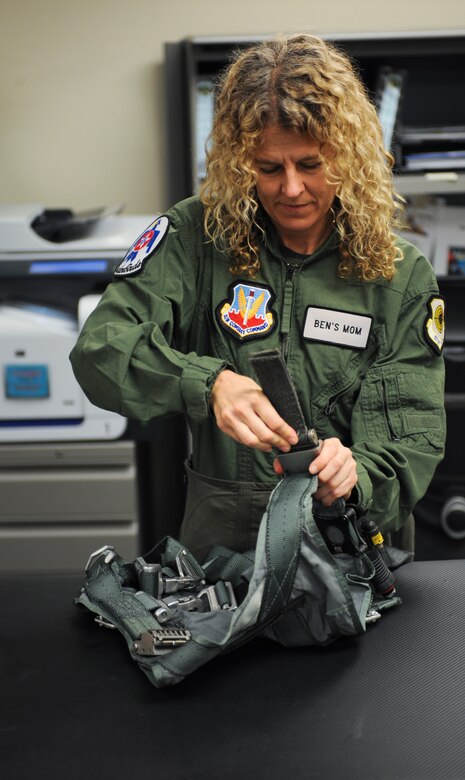 Jeannette Mare, founder and executive director of Ben’s Bells Project, performs a function test on her flight harness before a Hometown Hero Flight at Davis-Monthan Air Force Base, Ariz., April 10, 2014. Mare checks her gear to ensure that all safety precautions have been met. (U.S. Air Force photo by Senior Airman Sivan Veazie/Released)